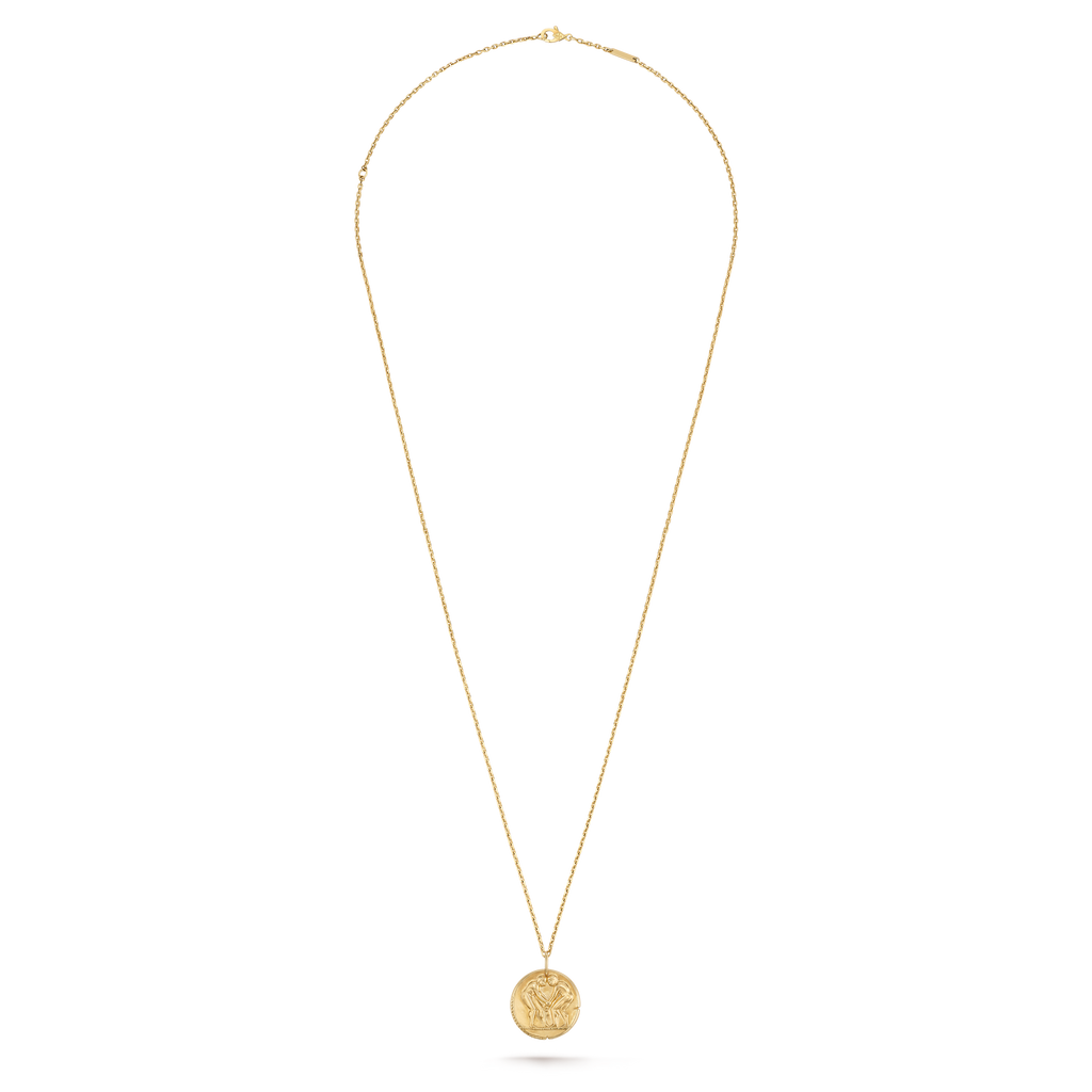 Van Cleef & Arpels Zodiaque Collection "Geminorum" (Gemini) gold medallion pendant featuring a relief design.