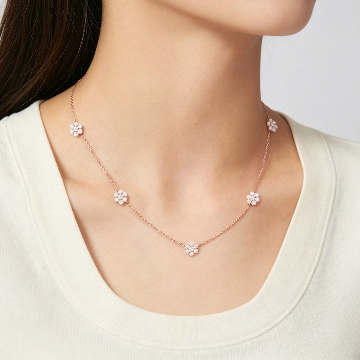 Van Cleef & Arpels Fleurette necklace featuring five diamond-pavé floral motifs.