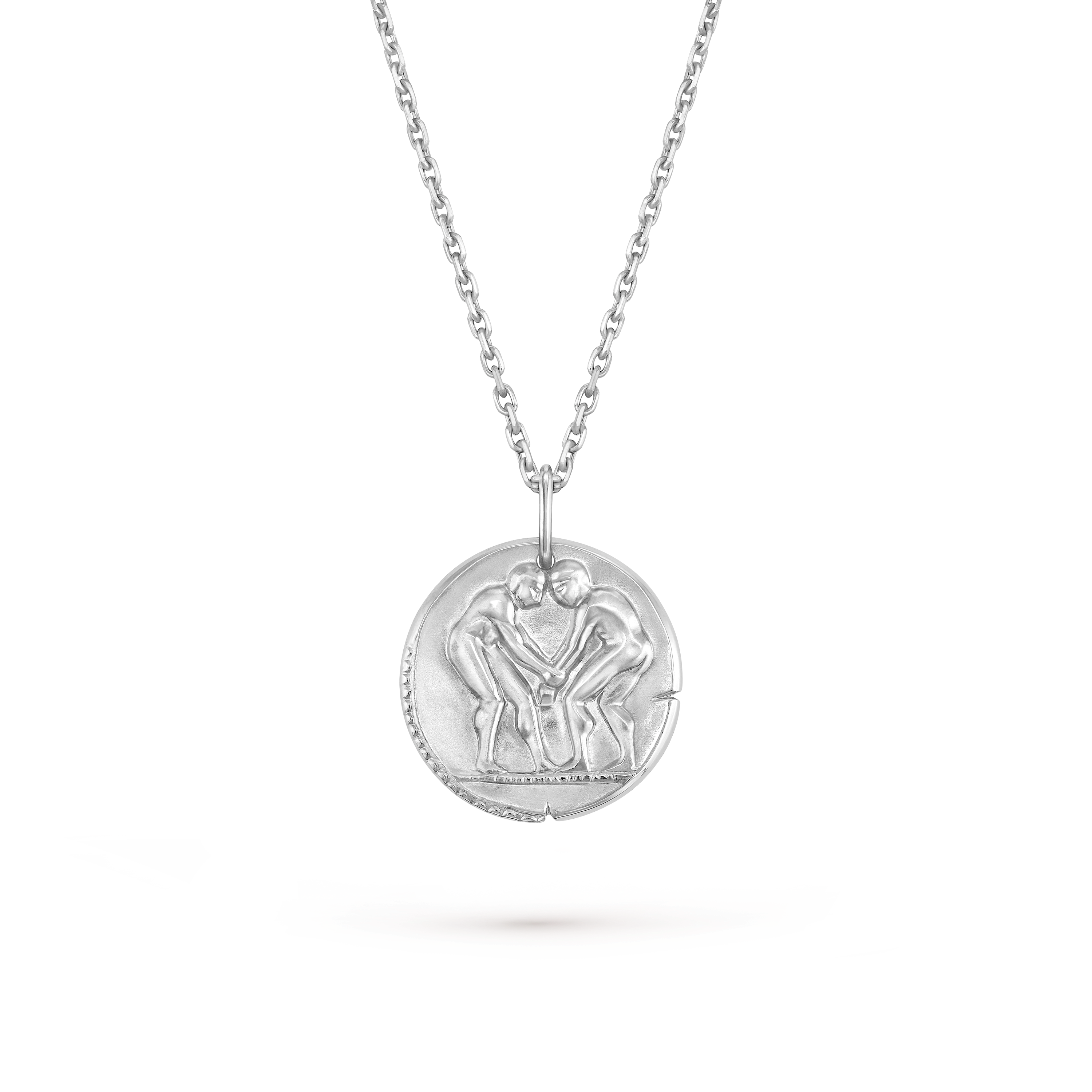 Van Cleef & Arpels Zodiaque Collection "Geminorum" (Gemini) gold medallion pendant featuring a relief design.