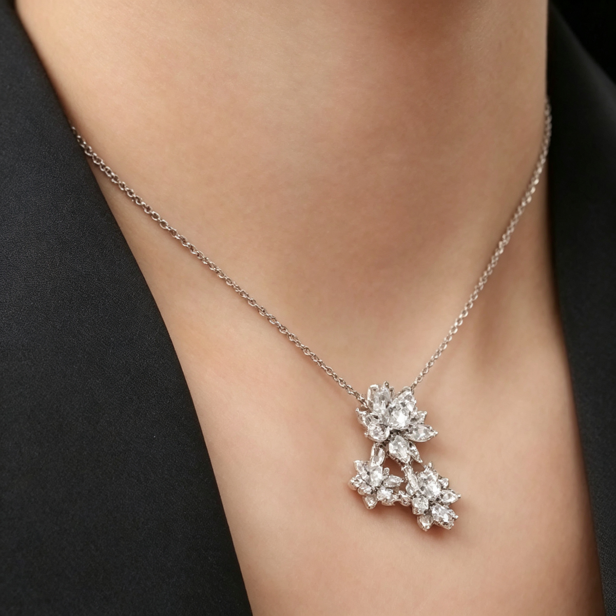 This is a Van Cleef & Arpels Cosmos collection pendant necklace in white gold featuring three flower motifs.